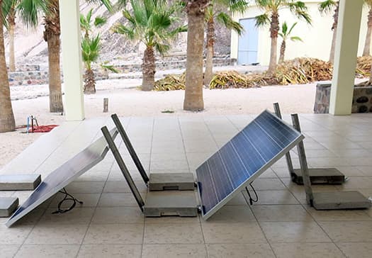 Two Pinpoint Solar fixed-angle ballasted mounting prototypes supporting photovoltaic panels